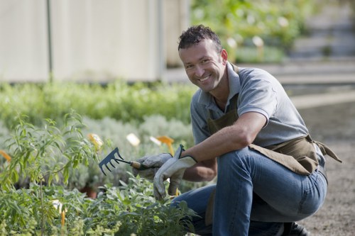 Weeds being removed from a landscaped garden area